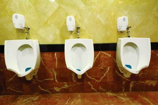 Three Urinals in a row.