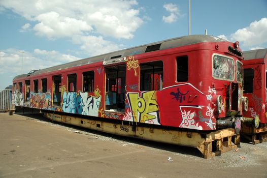 An old train is painted with graffiti