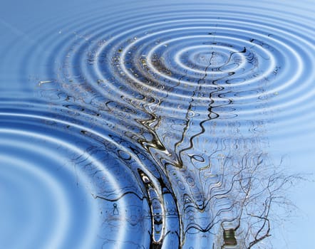 Blue sky with clouds reflected in a water pond