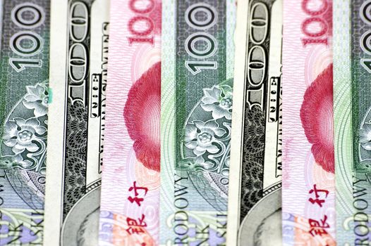 Polish zlotych, Chinese RMB and American dollar, banknotes in one row. Photo of different banknotes, money in different shapes and colors. Useful for financial, economic backgrounds.