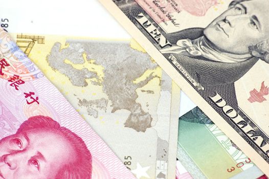 Closeup photo of USD, Euro and Chinese RMB. Photo of different banknotes, money in different shapes and colors. Useful for financial, economic backgrounds.