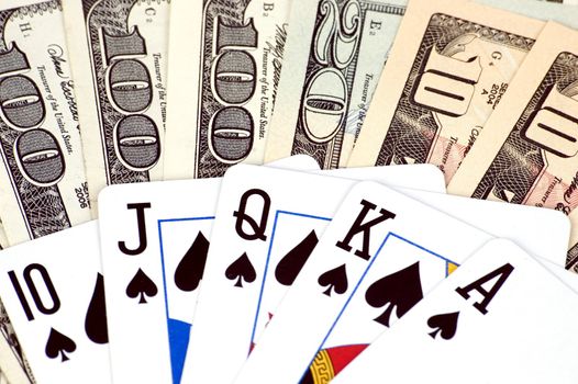 Gambling - American dollars and poker cards. Photo of different banknotes, money in different shapes and colors. Useful for financial, economic backgrounds.