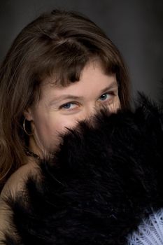 Portrait of the girl with a fan in hand