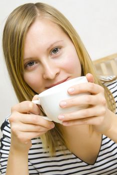 Beautiful girl holding a cup of coffee or tea