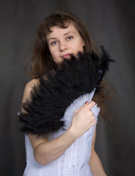 Portrait of the girl with a fan in hand