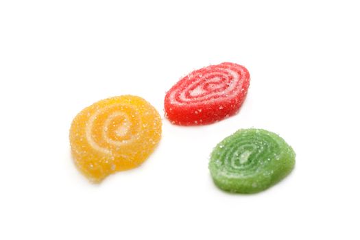 Colour fruit jellies in sugar on white background