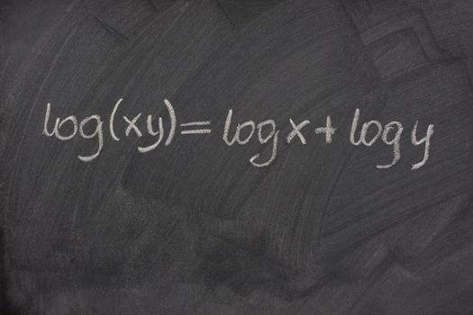 logarithm formula (reduction of multiplication to addition) handwritten with white chalk on a school blackboard with eraser smudges and pattern