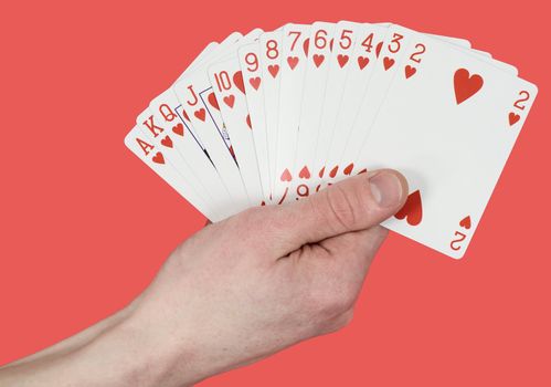 Playing cards on hand on the red background