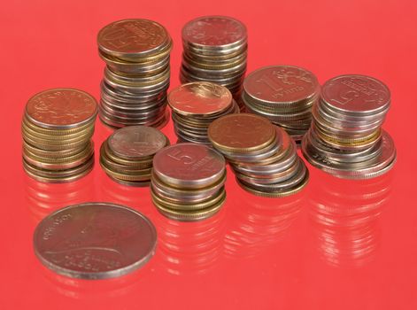 Rolls of the metal russian coins on red background