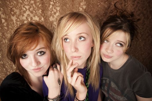 Portrait of three pretty young girls on a gold background