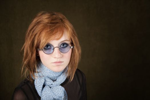Pretty teenage girl with round blue sunglasses