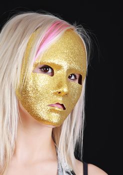 young blond girl with gold mask, black background