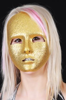 cute young blond girl with gold mask