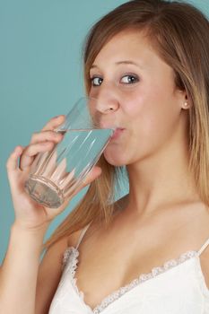 young caucasian woman drinking a glass of fresh water