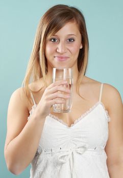 young caucasian woman holding a glass of fresh water