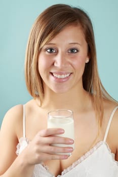 young caucasian woman holding a glass of fresh milk