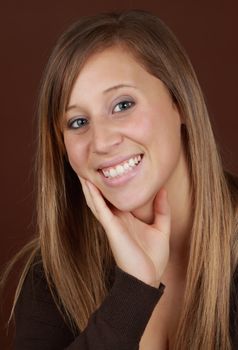 young caucasian woman, brown background