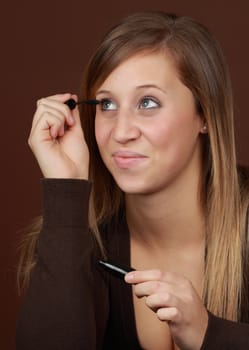 young caucasian woman applying mascara