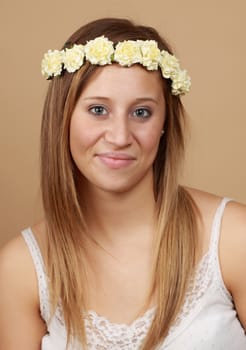 young caucasian woman with crown of fake flowers