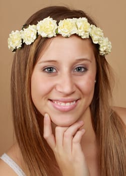 young caucasian woman with crown of fake flowers