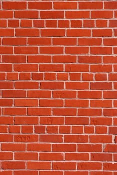 Red brick wall with light cement in between.