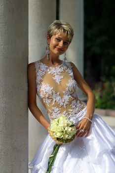 The beautiful bride with a bouquet from roses