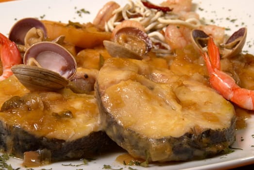 Hake with seafood in cider sauce, Spanish recipe