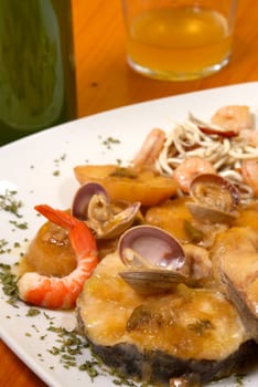 Hake with seafood in cider sauce, Spanish recipe