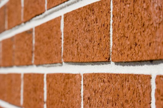 red brick wall close up shot with selective focus drifting off to blurry.