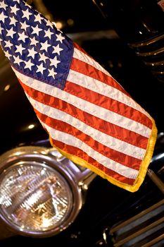 us flag on the bumper of a black car