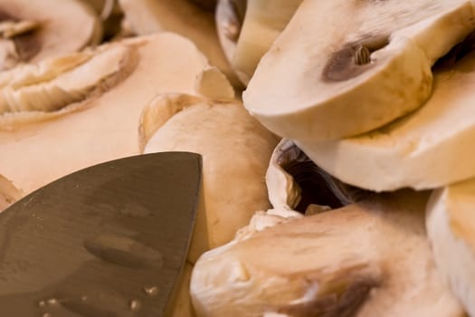 cut up mushrooms wet and sliced on a cutting board