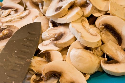 cut up mushrooms wet and sliced on a cutting board