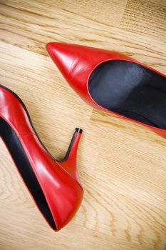 fashionable female shoes on wooden floor