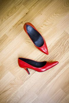 fashionable female shoes on wooden floor