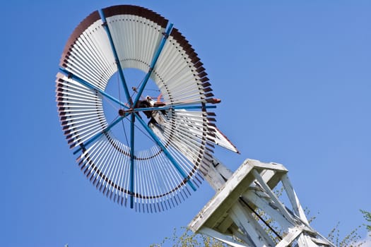 old windmill against a blue sky nice green background image