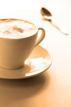 Cup of hot cappuccino, close-up. At the bottom  copyspace. Image tinted