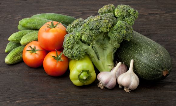 Still life with vegetables on a dark desk
