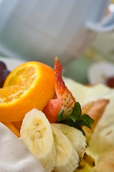 a light and healthy breakfast fresh fruit on white china