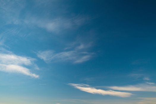 Large fragment of the sky with a few cirrus clouds. Photos shot with a polarizing filter. Abstract beautiful backdrop for any purpose