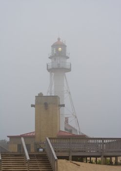 lighthouse in northern michigan on lake superior foggy and the light is working