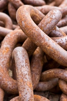 old rusty chain close up laying on the beach