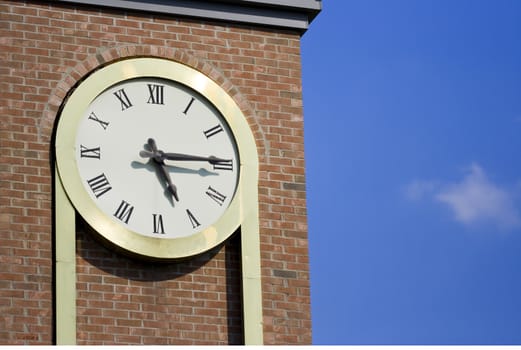 it's 5 oclock somewhere but it's 5:15 on my clock on a brick tower with a nice blue sky and a small cloud