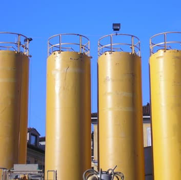 Yellow water tanks over a blue sky