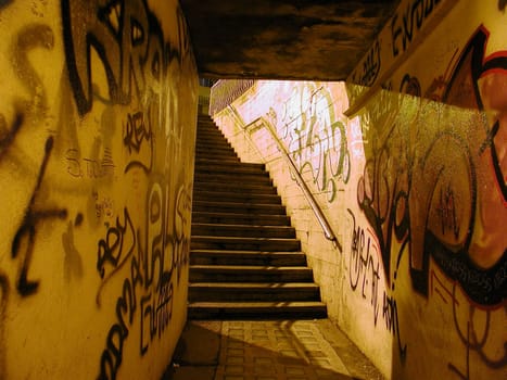 Pedestrian subway underpass with graffiti at night