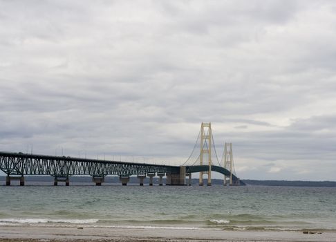 Mackinaw (Mackinac)  bridge on a cloudy day in northern Michigan it's an suspension bridge.  The Mackinaw bridge connects the upper peninsula to the lower peninsula.  The bridge was Open to traffic November 1, 1957.  The Mackinac bridge is also know as the mighty mac