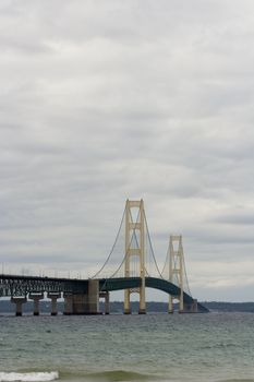 Mackinaw (Mackinac)  bridge on a cloudy day in northern Michigan it's an suspension bridge.  The Mackinaw bridge connects the upper peninsula to the lower peninsula.  The bridge was Open to traffic November 1, 1957.  The Mackinac bridge is also know as the mighty mac