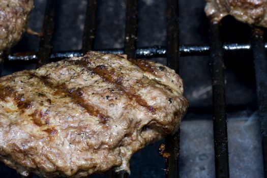 Grilling burgers on the bbq in the backyard for summer fun