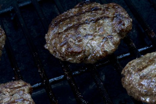 Grilling burgers on the bbq in the backyard for summer fun