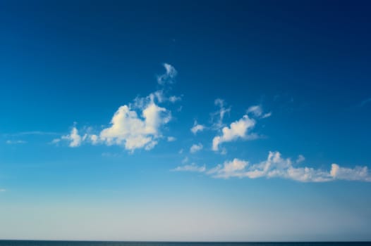 White clouds high above the sea surface