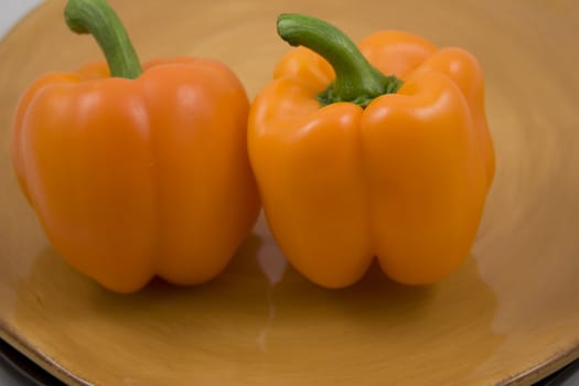 Orange peppers on a plate waiting for the salad
